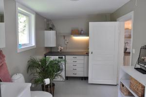 a kitchen with a white door and a sink at Grönhagen in Loftahammar +23 photos