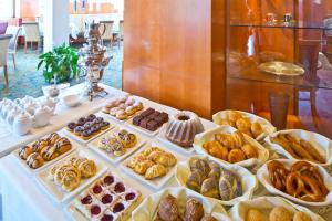 a table filled with different types of pastries and desserts at Hotel Penz West in Innsbruck