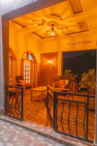 a living room with a porch with chairs and a table at MIRAMAR Ruhondo Resort in Muhororo