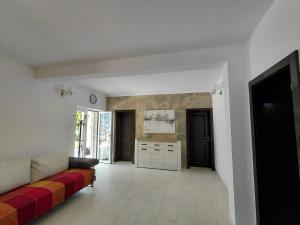 a living room with a couch and a kitchen at Muo sea view Garden in Muo +18 photos