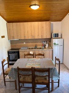 a kitchen with a table and chairs and a refrigerator at Natural retreat in Makri