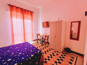 a bedroom with a bed and a table and a mirror at Nightstars B&B in Mestre
