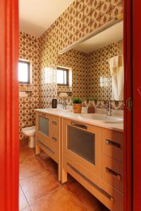 a bathroom with two sinks and a toilet at Cortijo Santa Cruz in Almuñécar +22 photos