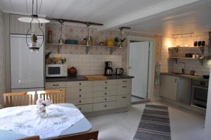 a kitchen with a table with a flower on it at Grönhagen in Loftahammar