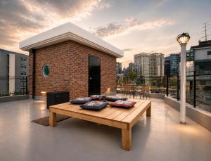 a balcony with a table on top of a building at Anguk House # Private 2F-3F Rooftop # Gyeongbokgung 1min # Bukchon in Seoul
