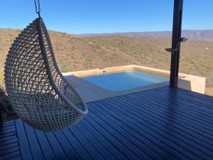 a hammock on a deck with a swimming pool at Eldorado TopHouse in McGregor