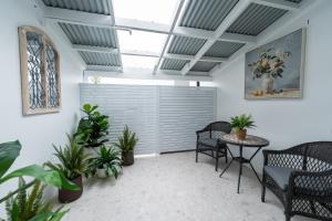 a room with chairs and a table with plants at Camden Hotel Suites in Camden