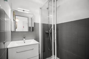 a bathroom with a shower and a sink and a mirror at T2 dans résidence arborée in Six-Fours-les-Plages +12 photos