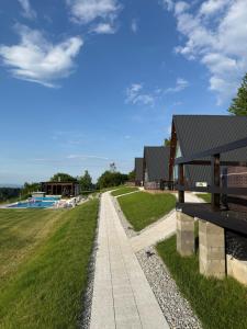 a walkway in front of a building with a grass field at Escape in Ghelar