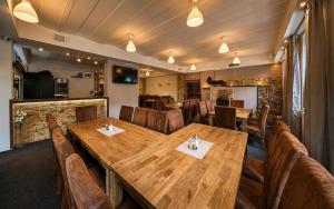 a dining room with a wooden table and chairs at Bouda Morava - snídaně v ceně - klidné Krkonoše in Dolni Dvur
