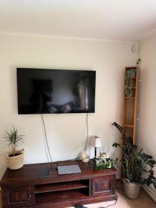 a living room with a tv on a wall at Örkelljunga Hostel in Orkelljunga