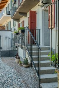 a stairway with potted plants and a red door at HB Boutique Apartment in Arco