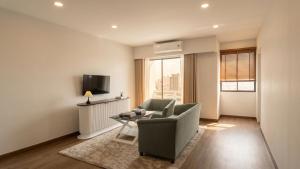 a living room with a couch and a table at Tittower in Bangkok