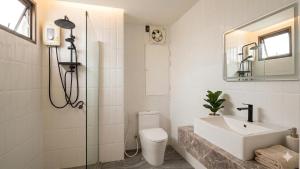 a bathroom with a sink and a toilet and a shower at Tittower in Bangkok