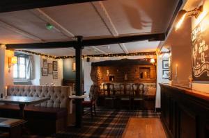 a bar with a table and chairs in a room at Mason's Arms in Montacute +1 photo