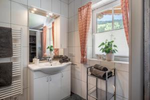 a bathroom with a sink and a window at Appartement Irmgard in Brixen im Thale +23 photos