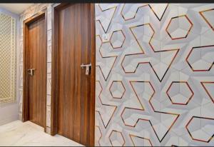 a room with a door and a wall with a pattern at All sana guest house in Kolkata +7 photos