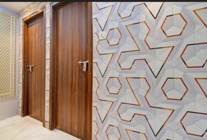 a room with a door with a patterned wall at All sana guest house in Kolkata