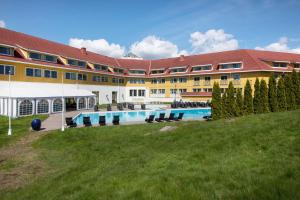 a large building with a swimming pool in a yard at Scandic Sørlandet in Kristiansand