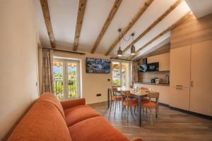 a living room and kitchen with a couch and a table at HB Boutique Apartment in Arco +44 photos