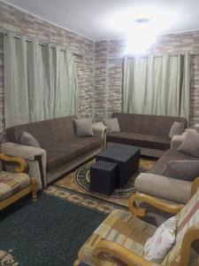 a living room with two couches and a couch at El Shibli Chalet in Jerash