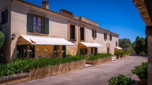 an old building with umbrellas on a street at Agroturisme Son Cardaix in Artá