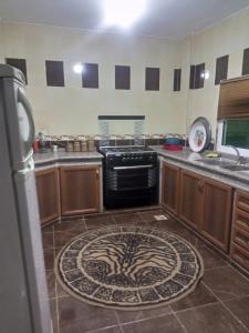 a kitchen with a sink and a stove at El Shibli Chalet in Jerash