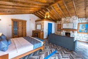 a bedroom with a bed and a stone wall at Adella Garden Marina Hotel in Güvercin Adası +25 photos