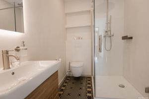 a bathroom with a sink and a toilet and a shower at Haus Auf der Zinn in Beilstein +17 photos