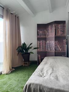 a bedroom with a bed and a potted plant at Oreneta in Fatarella +26 photos