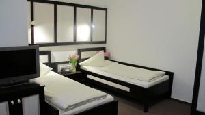 Postel nebo postele na pokoji v ubytování Hotel Anlage Heidelberg