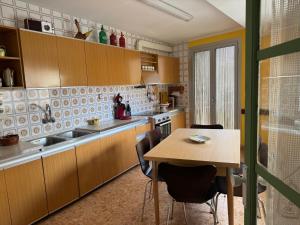 a kitchen with a wooden table and a table and chairs at Oreneta in Fatarella