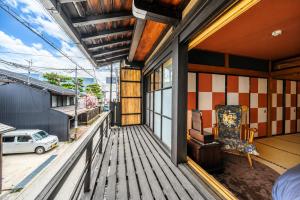 a porch of a house with a chair on it at とれるの【TORERUNO】 in Takayama