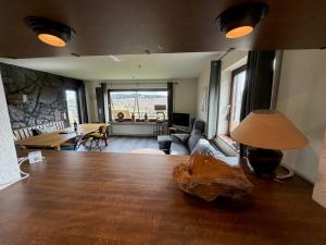 a living room with a table with a lamp and a couch at Haus Aktiv Garten2 in Winterberg +29 photos