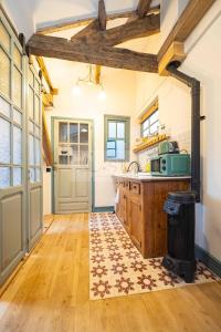 a kitchen with a wooden floor and a counter top at Sol By Silastur in Villaviciosa