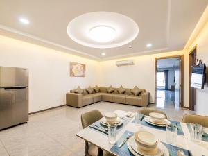 a living room with a table and a couch at H Resident in Phnom Penh