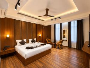 a bedroom with a large bed and a table at Casa Grande in Srinagar