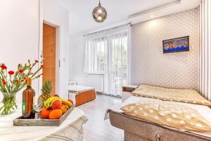a bedroom with two beds and a tray of fruit at WillaSimi in Władysławowo