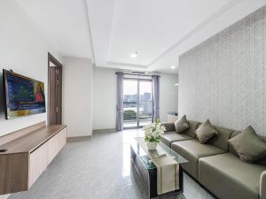 a living room with a couch and a table at H Resident in Phnom Penh