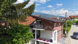 a small house with a balcony on a street at Blue Nest in Plav
