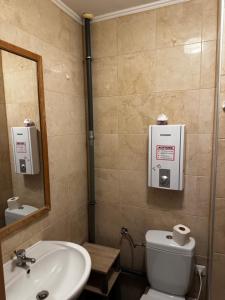 a bathroom with a sink and a toilet and a mirror at Monteurzimmer Drei Gleichen in Günthersleben