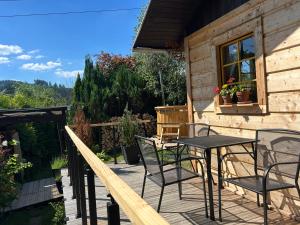 a patio with chairs and a table on a house at Medový domek Nový Hrozenkov in Nový Hrozenkov