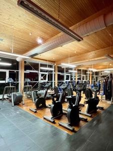 a gym with many rows of exercise equipment in a room at Vitalhotel Quellengarten - Bed & Breakfast in Lingenau