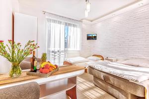 a room with a bed and a table with fruit on it at WillaSimi in Władysławowo