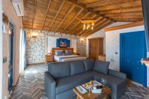 a living room with a couch and a bed at Adella Garden Marina Hotel in Güvercin Adası