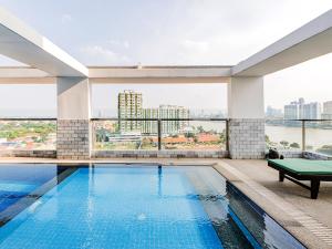 a swimming pool with a view of a building at H Resident in Phnom Penh