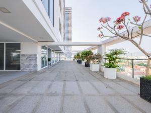 an empty hallway in a building with potted plants at H Resident in Phnom Penh