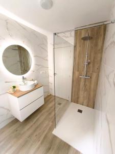 a bathroom with a shower and a sink and a mirror at Casa Gaia Centrally located accommodation with spacious rooms in Redondela