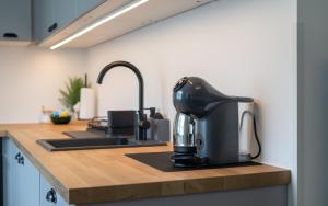 a coffee maker sitting on a kitchen counter at Hygge House Elva in Elva +1 photo