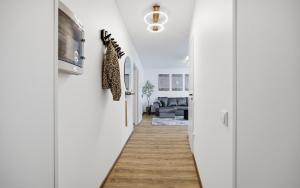 a hallway leading to a living room with white walls at Hygge House Elva in Elva
